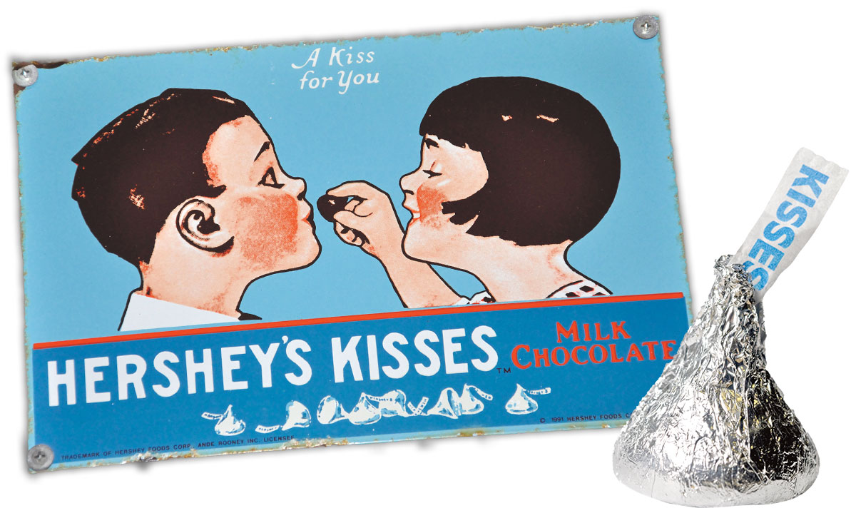 vintage ad of a girl feeding a boy a Hershey kiss