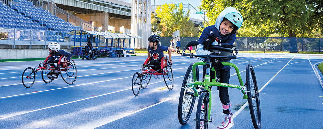 Image of kids participating in wheelchair racing