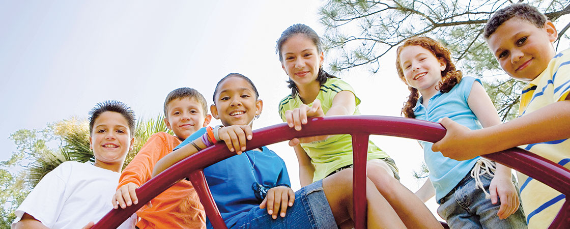 Smiling children on a monkey bar